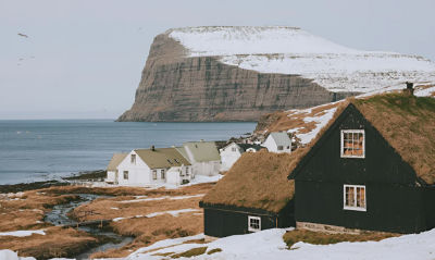 AI-generated image of a Nordic coastal village with turf-roof houses