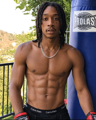 AI-generated image of Wiz Khalifa posing with boxing gloves and no tattoos 