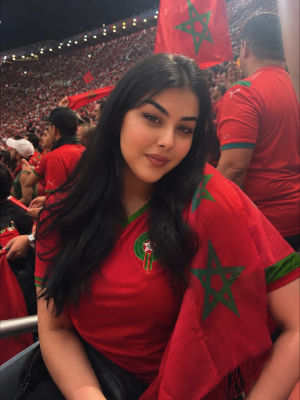 AI-generated image of a woman in Morocco jersey at a World Cup match