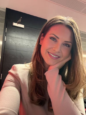 Deepfake selfie of an unidentified woman smiling indoors