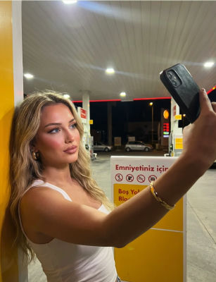 AI-generated image of Bar Refaeli taking a selfie at a gas station