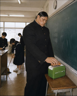 AI-generated Japanese classroom meme with muscular student and eraser device