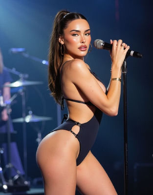 AI-generated image of Madison Beer performing on stage in a black bodysuit