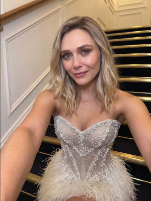 AI-generated image of Elizabeth Olsen in beaded feathered gown on staircase