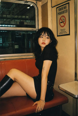 AI-generated portrait of an unidentified woman seated inside a subway car
