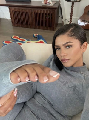 Deepfake resembling Zendaya in a gray loungewear selfie
