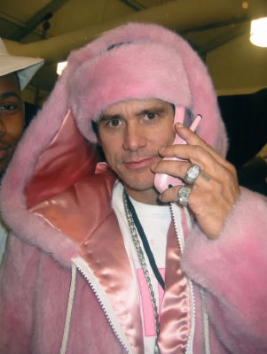 Deepfake of Jim Carrey holding a pink phone in a pink fur coat