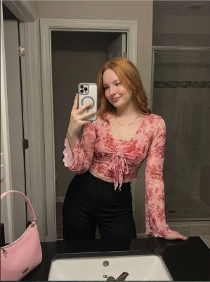 AI-generated mirror selfie of a young woman in a bathroom