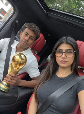 AI-generated photo of  Lamine Yamal and Mia Khalifa in a car with a World Cup trophy