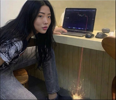 AI-generated image of an unidentified woman at a counter with a laptop and crystals