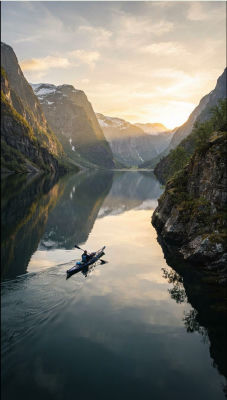 AI-generated image of a kayaker on a mountain fjord at sunset