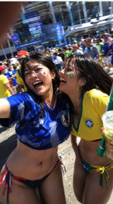 AI-generated image of two fans in Japan and Brazil jerseys at a World Cup fan zone