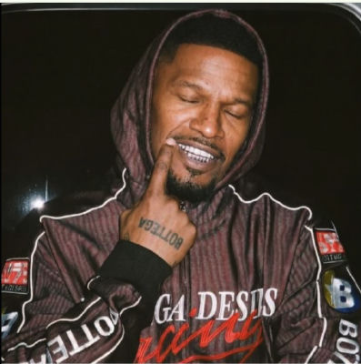AI-generated image of Jamie Foxx showing off diamond grills in a car
