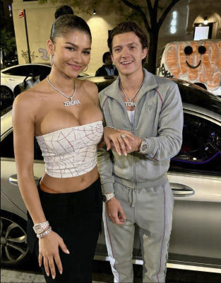 Deepfake of Zendaya and Tom Holland posing together on a city street at night