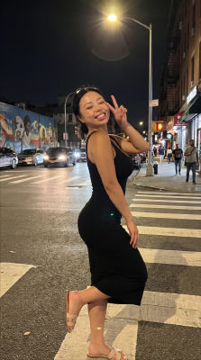 AI generated image of unidentified woman posing on a city street at night