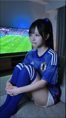 AI-generated image of woman in Japan national team kit watching soccer