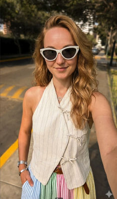AI-generated photo of a woman in sunglasses and pastel striped outfit on a street