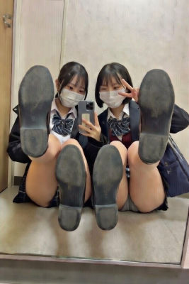AI-generated image of two unidentified young women in school uniforms, posed with shoes extended toward camera