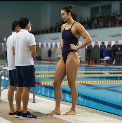 AI-generated image of unidentified woman in a swimsuit at a competition pool
