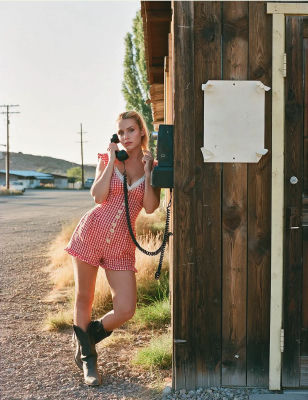 AI-generated image of Ksenia Sukhinova with a payphone in a rural setting