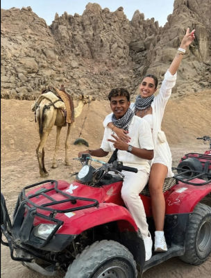 AI-generated image of two people on an ATV in a desert landscape