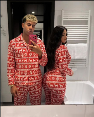 AI-generated image of Lamine Yamal and an unidentified young woman in matching Christmas pajamas