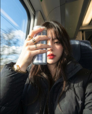 AI-generated image of a woman holding a can on a train
