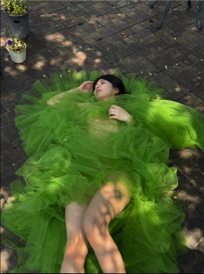 Deepfake of an unidentified woman in green tulle dress on patio
