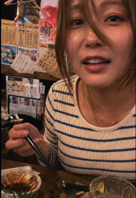 AI-generated image of a woman dining at a Japanese izakaya