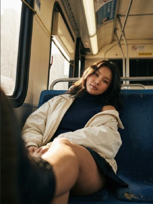 AI-generated image of an unidentified woman seated on a bus
