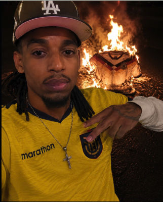 Reported AI-generated image of 'Blou' posing in front of a burning soccer jersey