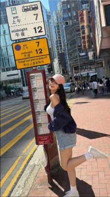 AI-generated photo of a woman posing at a Hong Kong bus stop