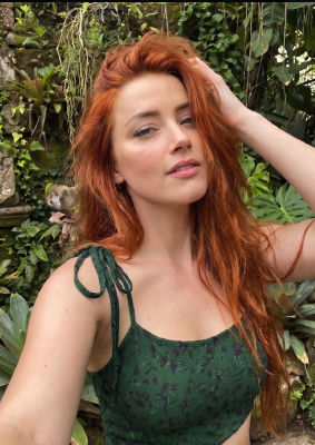 AI-generated image of Amber Heard posing in front of tropical greenery