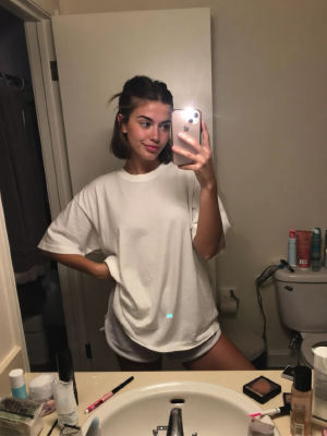 AI-generated mirror selfie of an unidentified woman in a bathroom