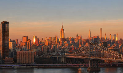 AI-generated sunset view of the New York City skyline with the Manhattan Bridge