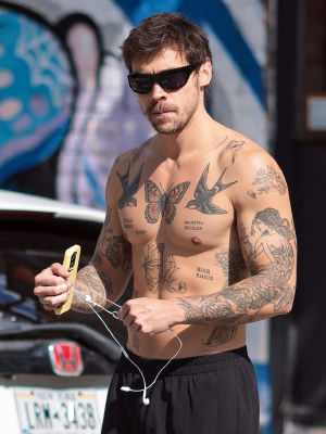 AI-generated image appearing to show Harry Styles shirtless with tattoos
