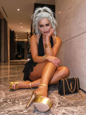AI-generated image of Emilia Clarke in a black halter dress with gold accessories