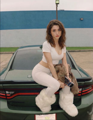 Deepfake of Natalia Dyer sitting on a Dodge Charger
