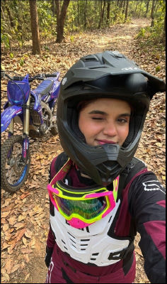 AI-generated selfie of a rider in motocross gear with a dirt bike