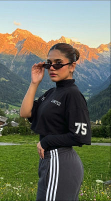 AI-generated image of a woman in athletic wear in an Alpine meadow