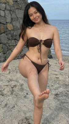 AI-generated image of a woman in a brown bikini on a beach