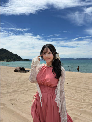 AI-generated portrait of a young woman posing on a beach