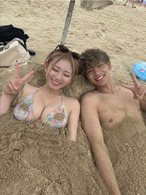 Deepfake of a couple buried in sand at the beach