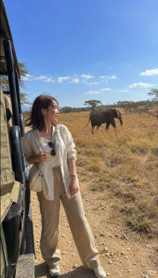 AI-generated image of a woman on safari with an elephant