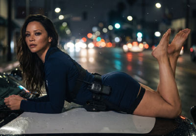 Deepfake of Melissa O'Neil lying on a police car at night