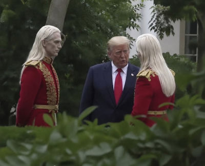AI-generated image of Donald Trump with pale-haired figures in red uniforms outdoors