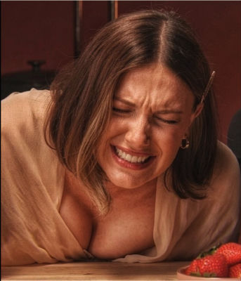 AI-generated image of Millie Bobby Brown grimacing near a bowl of strawberries