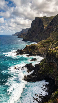 AI-generated coastal cliff landscape with crashing waves
