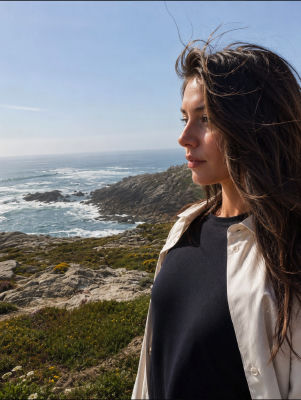 AI-generated image of a woman on a coastal cliff