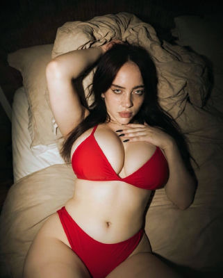 AI-generated image of Billie Eilish in red lingerie on a bed